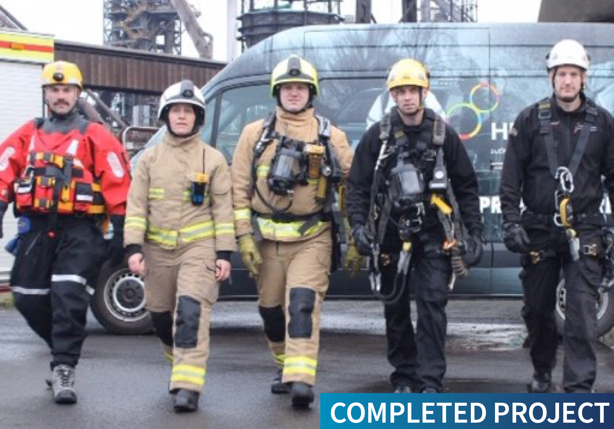 Humberside Fire and Rescue Solutions personnel in uniform in front of a liveried vehicle with the text Completed Project